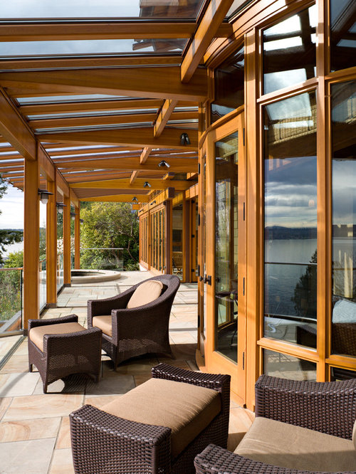 Eclectic Porch Seattle This is an example of an eclectic porch design in Seattle with a roof extension.