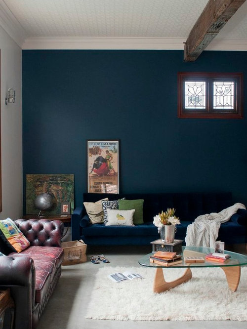 Eclectic Living Dunedin Inspiration for an eclectic living room remodel in Perth with concrete floors and blue walls