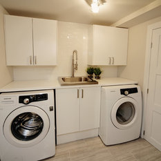 Modern Laundry Room Wales This completely updated laundry room with custom built in countertop, storage cabinets, stainless steel deep laundry sink, industrial faucet with extending ...