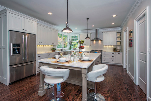 Bright White Kitchen with Stainless Steel Appliances and Oversized Island