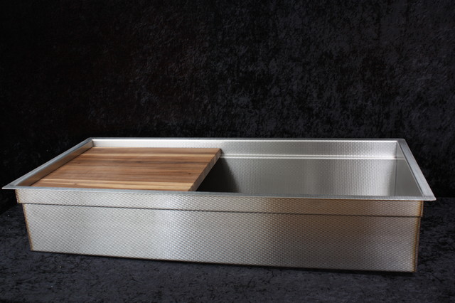 stainless kitchen sink with cutting board