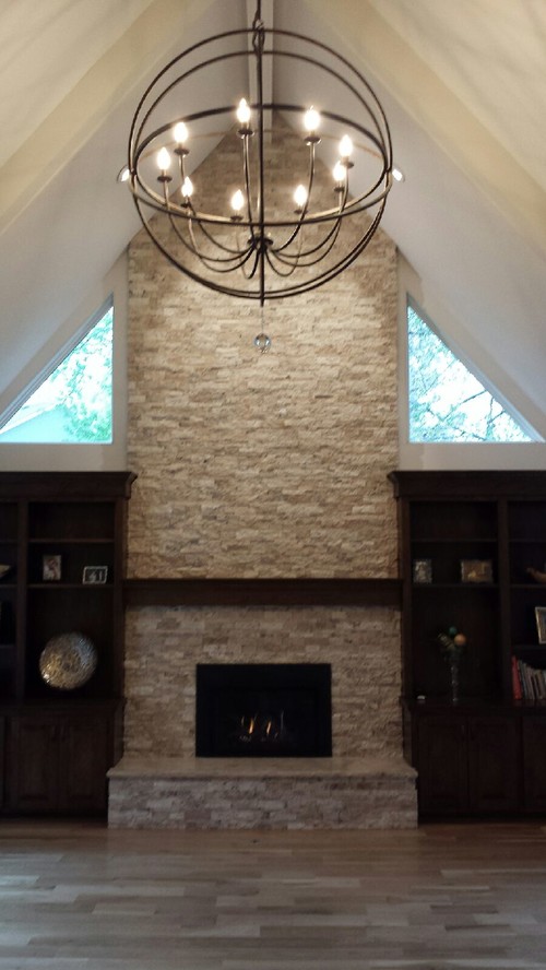 What should hang on the fireplace?