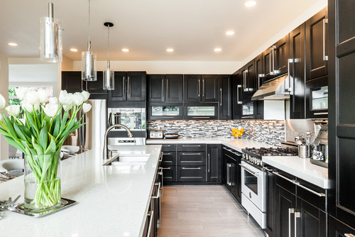 Black And White Kitchen Black Cabinets Stainless Steel Appliances Kitchen With Black Cabinets Cooking Space White Countertops Kitchen Cabinets Kitchen Island White Backsplash Black Kitchen Black Cabinetry
