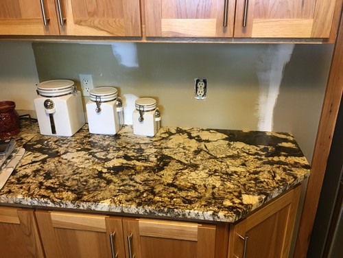 Need backsplash ideas for busy granite countertops in kitchen.