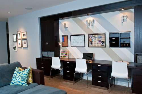 Contemporary homework station with black cabinets and recessed lighting