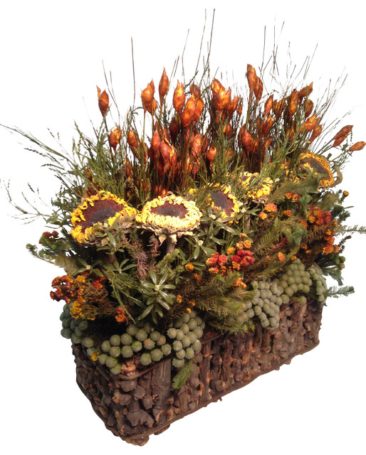 Dried stacked arrangement with sunflowers in rustic basket