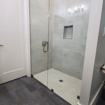 Elegant Shower done with 12x24 tiles and penny rounds.