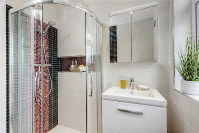 Mid-sized contemporary kids bathroom in London with a corner shower, a two-piece toilet, red tile, mosaic tile and a console sink.