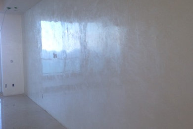 Example of a large trendy master bedroom design in Miami with beige walls