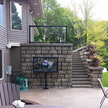 Outdoor Television on Concrete Patio with Stone Deck