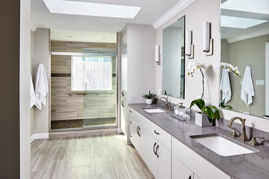 Transitional beige tile bathroom photo in DC Metro with white cabinets and gray countertops