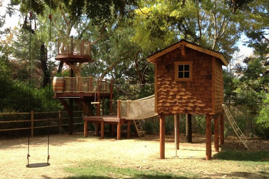 Photo of a mid-sized arts and crafts garden in San Diego with with outdoor playset.