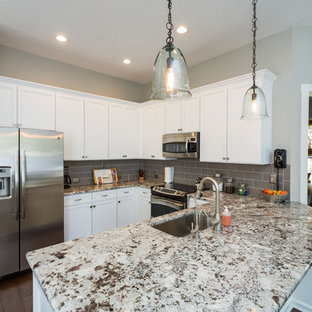 Large kitchen pantry ideas - Large l-shaped dark wood floor kitchen pantry photo in Jacksonville with a drop-in sink, recessed-panel cabinets, white cabinets, granite countertops, gray backsplash, subway tile backsplash and stainless steel appliances