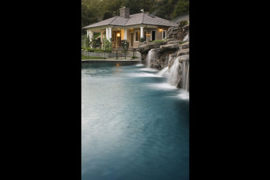 Pool house - huge traditional backyard custom-shaped natural pool house idea in Los Angeles