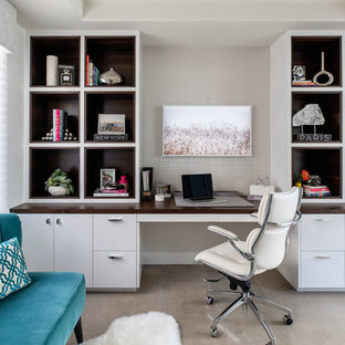 Design ideas for a medium sized modern study in San Diego with yellow walls, limestone flooring, a built-in desk and grey floors.