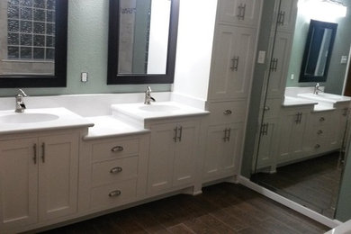 Mid-sized elegant master brown tile and ceramic tile porcelain tile bathroom photo in Austin with an integrated sink, shaker cabinets, white cabinets, solid surface countertops, a two-piece toilet and gray walls