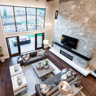 Mid-sized transitional open concept dark wood floor family room photo in Salt Lake City with gray walls, a standard fireplace, a stone fireplace and a wall-mounted tv