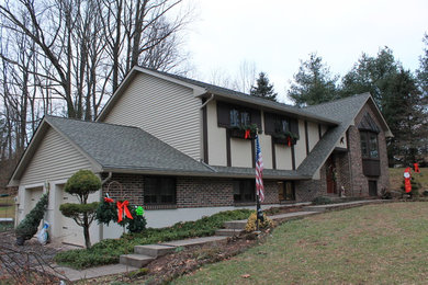 Inspiration for a beige two-story vinyl exterior home remodel in Philadelphia