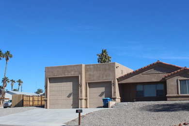 Example of a large southwest beige one-story adobe house exterior design in Phoenix with a tile roof and a brown roof