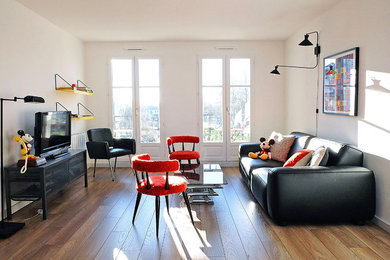 Trendy medium tone wood floor living room photo in Paris with white walls
