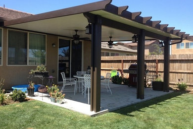 Design ideas for a medium sized classic back patio in Other with concrete slabs and an awning.