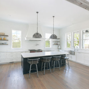 Large beach style kitchen pantry appliance - Large coastal u-shaped medium tone wood floor and brown floor kitchen pantry photo in Charleston with a farmhouse sink, shaker cabinets, blue cabinets, quartz countertops, white backsplash, porcelain backsplash, colored appliances, an island and white countertops