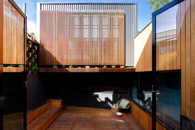 Design ideas for a mid-sized contemporary deck in Melbourne with a container garden and no cover.