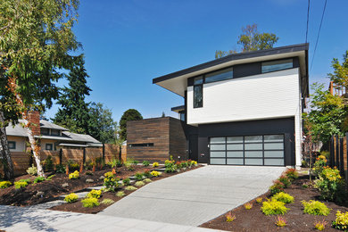 Large 1950s white two-story wood house exterior idea in Seattle