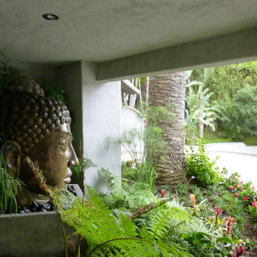 Water Constantly Cascades Down The Face Of The Magical Buddha Water Feature