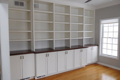 Mid-sized traditional study room in Philadelphia with grey walls, medium hardwood floors, no fireplace, brown floor and a built-in desk.