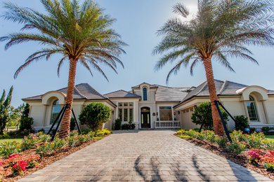 This is an example of a mediterranean full sun front yard brick driveway in Orlando.