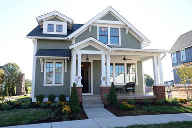 Large craftsman green two-story wood exterior home idea in Louisville