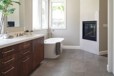 Mid-sized trendy master beige tile and ceramic tile double-sink, ceramic tile and gray floor bathroom photo in San Francisco with flat-panel cabinets, dark wood cabinets, quartz countertops, white countertops, a built-in vanity, a one-piece toilet, beige walls, an undermount sink and a hinged shower door