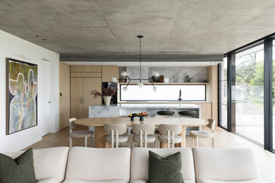 Contemporary open plan dining in Sydney with white walls, medium hardwood floors and brown floor.