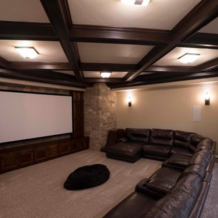 Inspiration for a timeless enclosed carpeted and beige floor home theater remodel in Las Vegas with beige walls and a media wall