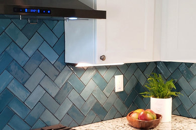 Minimalist kitchen photo in Sacramento with blue backsplash
