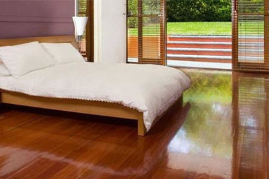 Large minimalist guest dark wood floor and brown floor bedroom photo in Orange County with purple walls and no fireplace