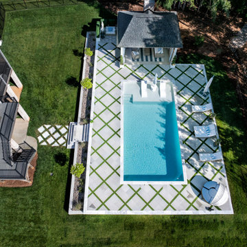 Modern Raised Concrete Pool with White Marble Pavers and Artificial Turf