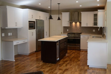 Eat-in kitchen - mid-sized modern u-shaped eat-in kitchen idea in Charlotte with shaker cabinets, white cabinets, granite countertops and an island
