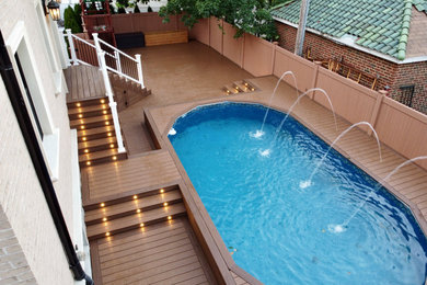 Example of a large classic backyard pool design in New York