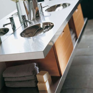 Idee per una stanza da bagno padronale minimalista con ante lisce, ante beige, vasca con piedi a zampa di leone, doccia ad angolo, piastrelle grigie, pareti bianche, pavimento in cemento, lavabo integrato e top in zinco