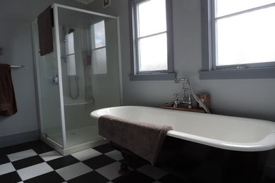 Inspiration for a small eclectic master bathroom in Hamilton with a claw-foot tub, a corner shower, black and white tile, ceramic tile, blue walls and ceramic floors.