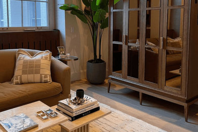 Inspiration for a small mid-century modern enclosed vinyl floor and brown floor living room remodel in New York with beige walls