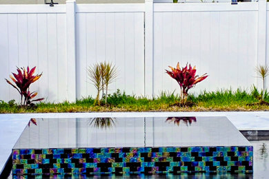 Inspiration for a large backyard hot tub remodel in Orlando