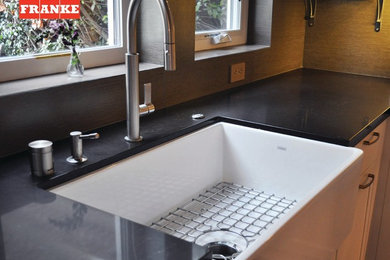 Inspiration for a modern kitchen remodel in Nashville with a single-bowl sink and solid surface countertops