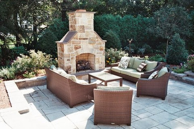 Inspiration for a mid-sized timeless backyard stone patio remodel in Boston with a fire pit