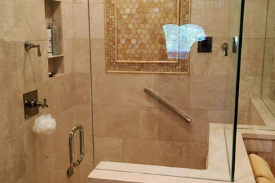 Inspiration for a large coastal master beige tile and travertine tile travertine floor and beige floor corner shower remodel in Denver with beige walls and a hinged shower door