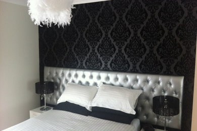 This is an example of an eclectic bedroom in Adelaide with black walls.