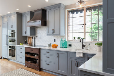 Kitchen - large traditional medium tone wood floor and brown floor kitchen idea in Seattle with an undermount sink, beaded inset cabinets, blue cabinets, quartz countertops, white backsplash, mosaic tile backsplash and paneled appliances