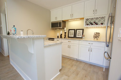 Wet bar - mid-sized traditional galley wet bar idea in Other with shaker cabinets, white cabinets, granite countertops and stone tile backsplash